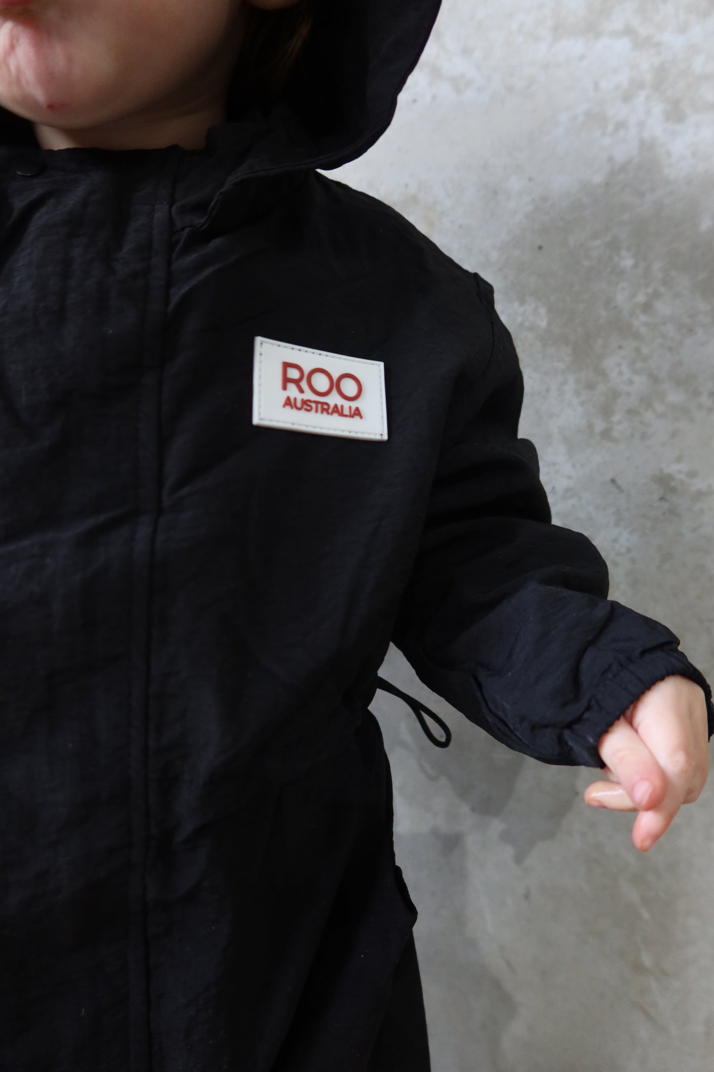 Close-up of chest area on the Windbreaker Boiler Suit, highlighting Roo Australia’s rubber logo.
